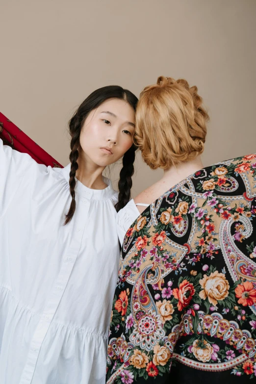 a woman combing another woman's hair in front of a mirror, inspired by Fei Danxu, trending on pexels, mannerism, wearing a long flowy fabric, studio shoot, russian clothes, hugging each other