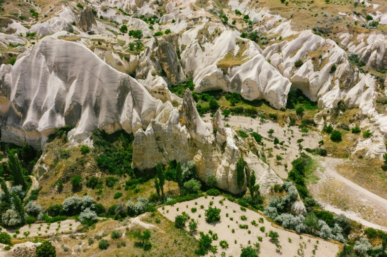 an aerial view of the landscape in cappadin national park, pexels contest winner, art nouveau, white, asymmetrical spires, erosion, beige