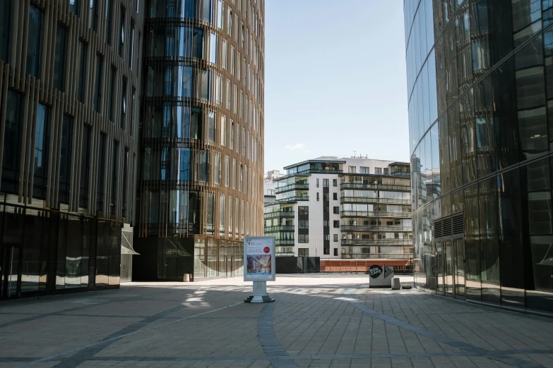 a bus driving down a city street next to tall buildings, a picture, by Tobias Stimmer, unsplash, modernism, bjarke ingels, in a square, berghain, portait image