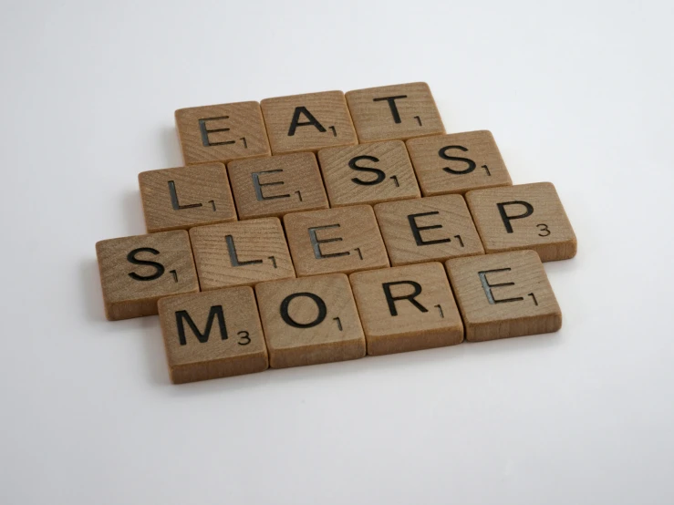 wooden scrabbles spelling eat less sleep more, by Elsie Henderson, letterism, teaser, asleep, eating, most memorable scene