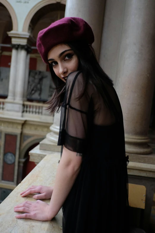 a woman posing for a picture on a balcony, by Lucia Peka, trending on pexels, renaissance, black beret, see through dress, 🤤 girl portrait, soft and blurry