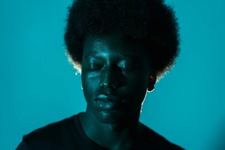 a close up of a person with a cell phone, an album cover, by Clifford Ross, pexels contest winner, les nabis, dark blue skin, portrait top light, afro, thinker