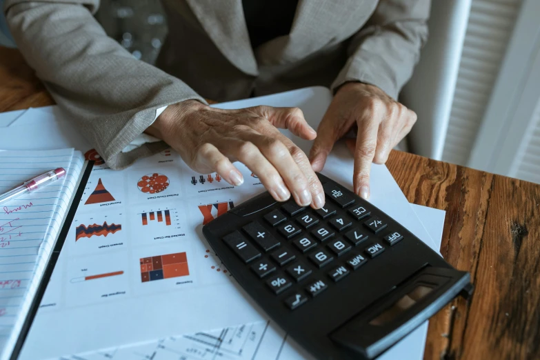 a close up of a person using a calculator, trending on pexels, analytical art, avatar image, fan favorite, a wooden, 1 2 9 7