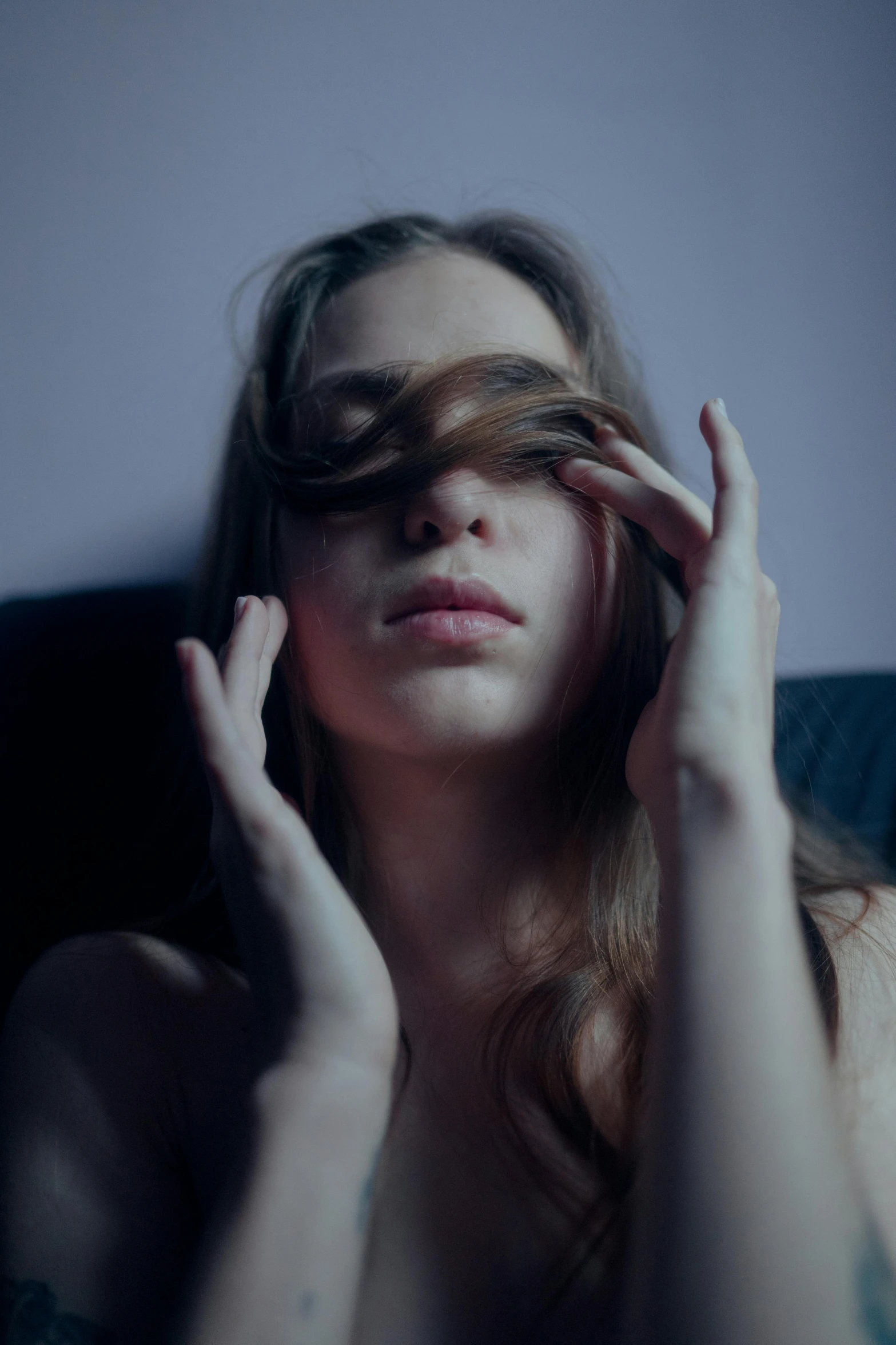 a woman sitting in a chair with her eyes closed, a picture, inspired by Elsa Bleda, trending on pexels, renaissance, hair covering eyes, mid night, intimately holding close, teenage girl