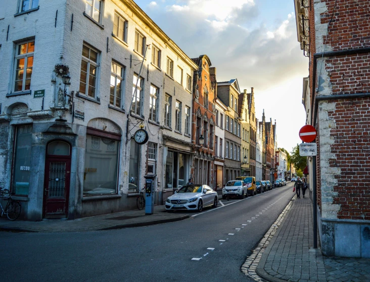 a street with cars parked on the side of it, by Daniel Seghers, pexels contest winner, renaissance, flanders, late afternoon, a quaint, hd footage