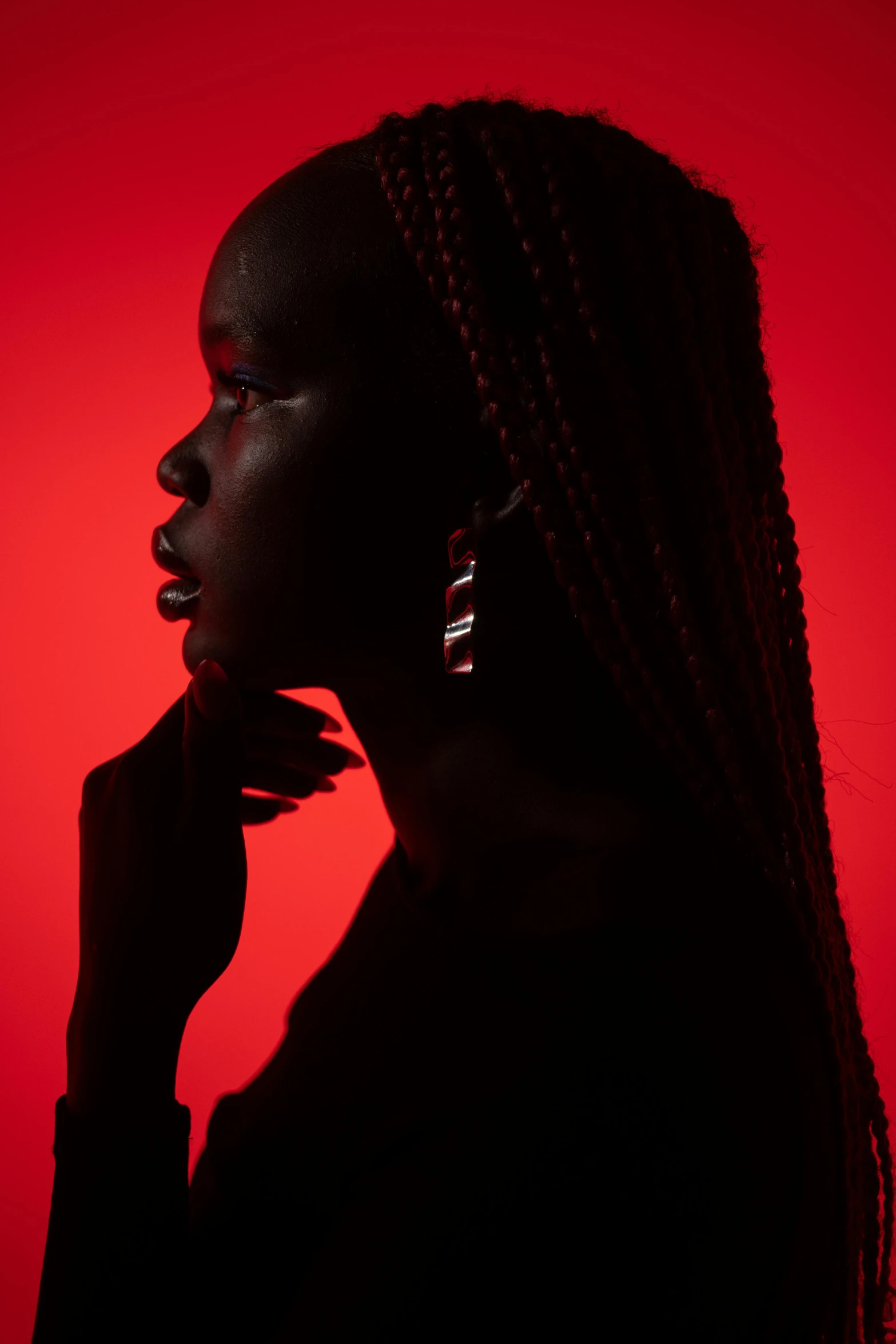 a woman is silhouetted against a red background, pexels contest winner, afrofuturism, medium format. soft light, jewelry photography, black teenage girl, dramatic lighting - n 9