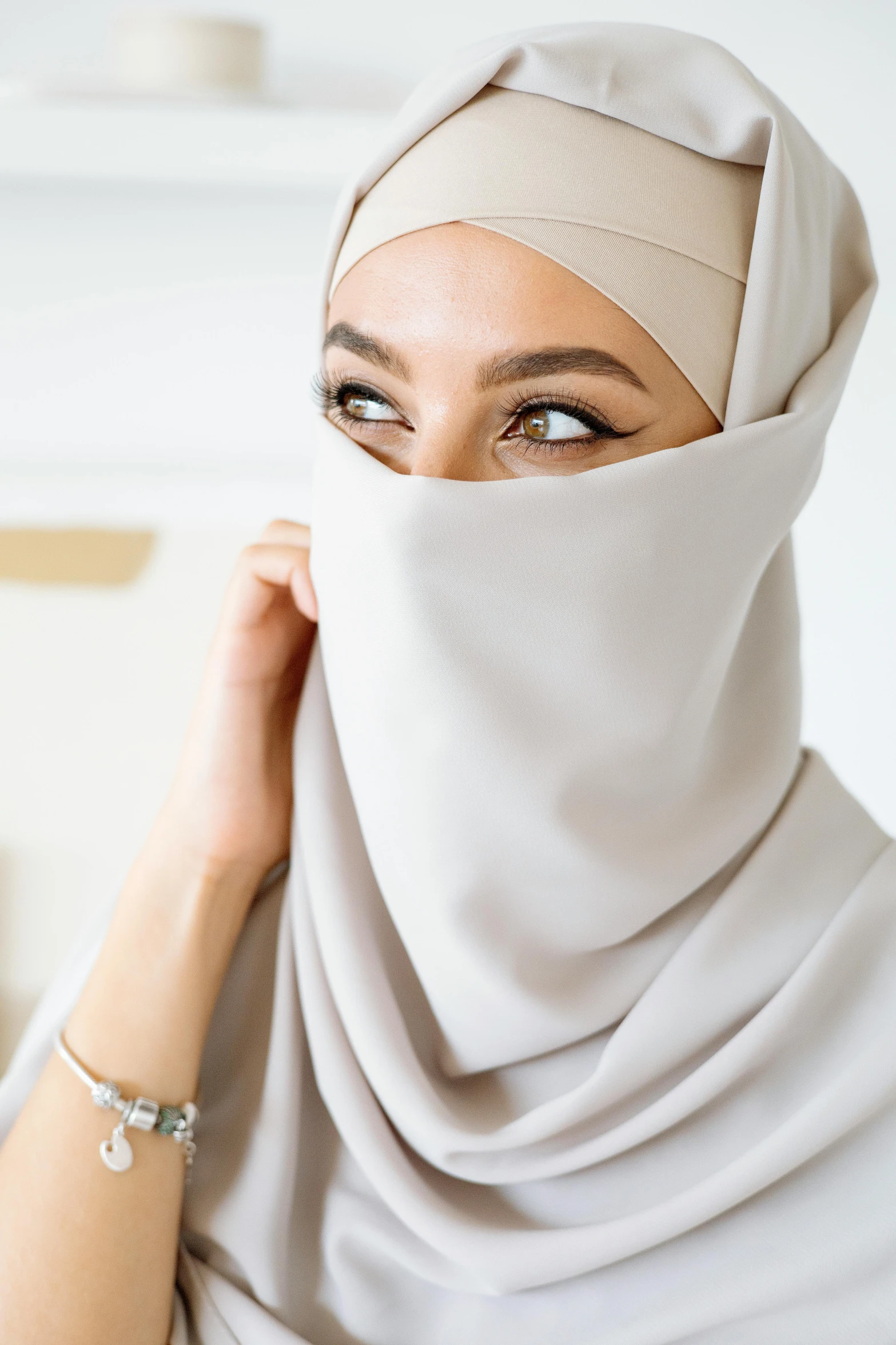 a woman wearing a hijab covering her face, trending on pexels, hurufiyya, beige mist, front on, vanilla, dynamic closeup