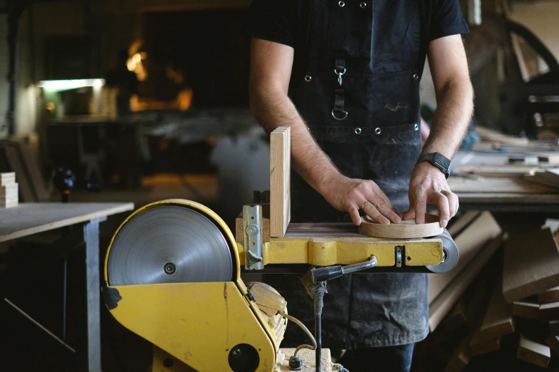 a man using a band saw to cut a piece of wood, pexels contest winner, arts and crafts movement, worksafe. instagram photo, dwell, in a workshop, gilt-leaf winnower