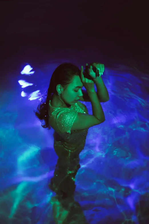 a woman that is standing in some water, an album cover, inspired by Elsa Bleda, unsplash, high blue lights, dancefloor kismet, isabela moner, pose 4 of 1 6