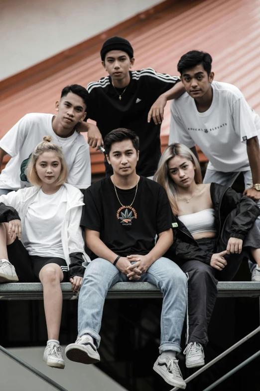 a group of young people sitting on top of an escalator, by Robbie Trevino, trending on unsplash, outlive streetwear collection, south east asian with round face, band promo photo, sits on a rooftop