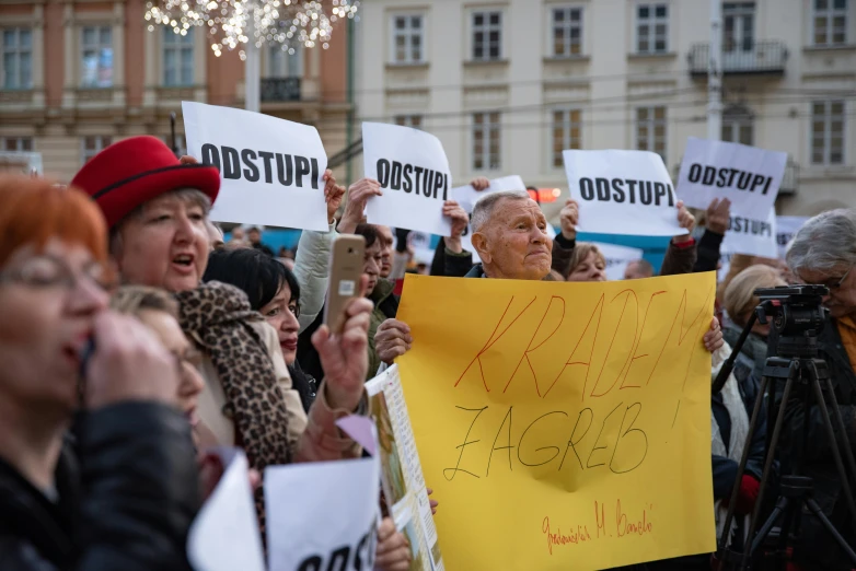 a group of people holding signs in front of a building, by karolis strautniekas, shutterstock, antipodeans, square, osr, crowds panic, photograph credit: ap