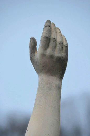 a close up of a statue of a person's hand, sydney hanson, tall, religious, grey