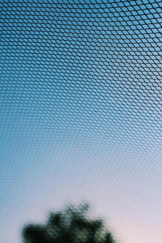 a man standing on top of a tennis court holding a racquet, an album cover, inspired by Andreas Gursky, unsplash, net art, fish scales, gradient light blue, abstract detail, fishnet