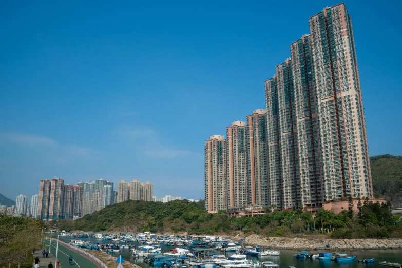 a harbor filled with lots of boats next to tall buildings, pexels contest winner, hyperrealism, chinese building, apartment complex made of tubes, a large, coast