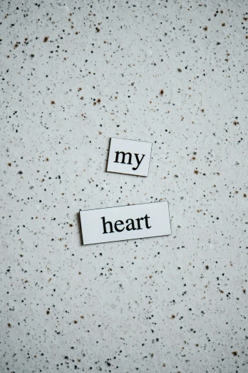 a piece of paper with the words my heart cut out of it, trending on pexels, magnetic, concrete poetry, silver，ivory, enamel