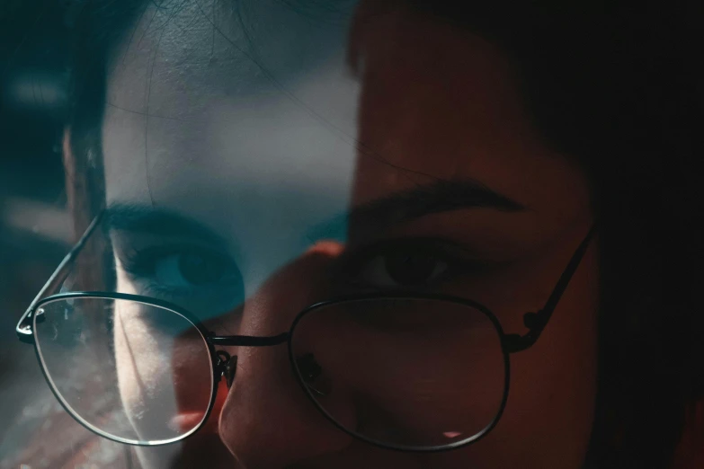 a close up of a person wearing glasses, admiring her own reflection, cinematic post - processing, shadowed face, instagram picture