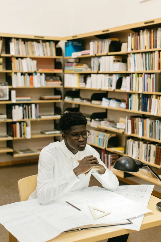 a woman sitting at a desk in a library, by Barthélemy Menn, trending on unsplash, academic art, black teenage boy, wearing white suit and glasses, architect, wearing an academic gown