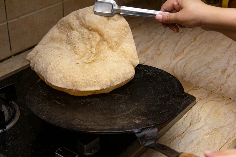 a close up of a person cooking food on a stove, flat pancake head, shakti, thumbnail, fan favorite