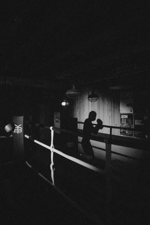 a black and white photo of people in a dark room, a black and white photo, unsplash, boxing ring, silhouette of a man, lo-fi, ✨🕌🌙