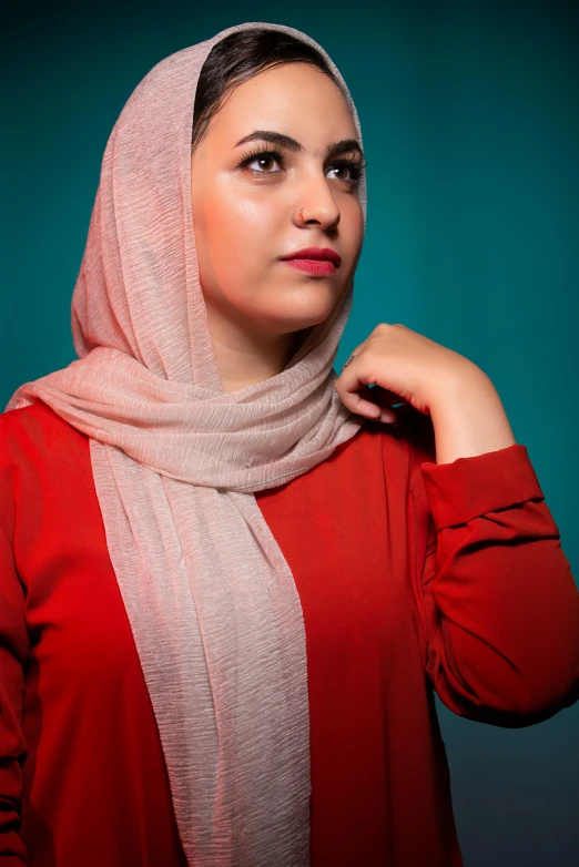 a woman in a hijab poses for a picture, an album cover, pexels contest winner, teal silver red, studio portrait photo, ((portrait)), casually dressed