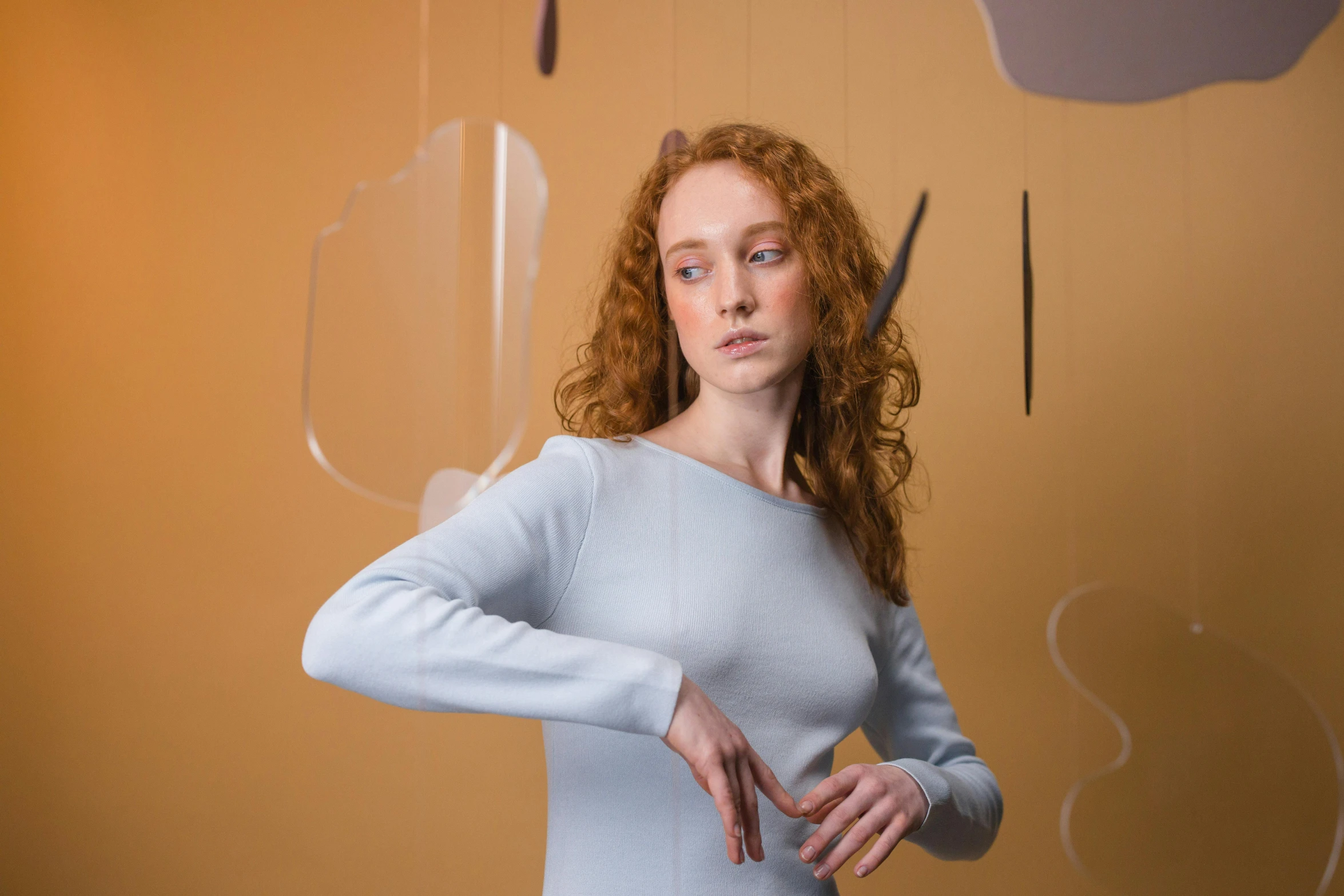 a woman making a heart with her hands, an album cover, inspired by Vanessa Beecroft, pexels contest winner, pale blue outfit, eleanor tomlinson, cloud jumper, marvelous designer substance