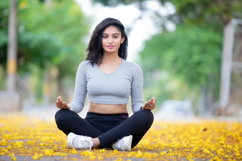 a woman sitting on the ground doing yoga, a portrait, pexels contest winner, hurufiyya, avatar image, handsome girl, uncropped, spring season