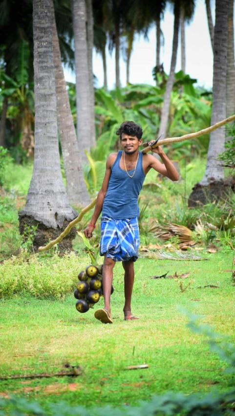 a young boy walking across a lush green field, coconuts, carrying two barbells, malayalis attacking, slide show