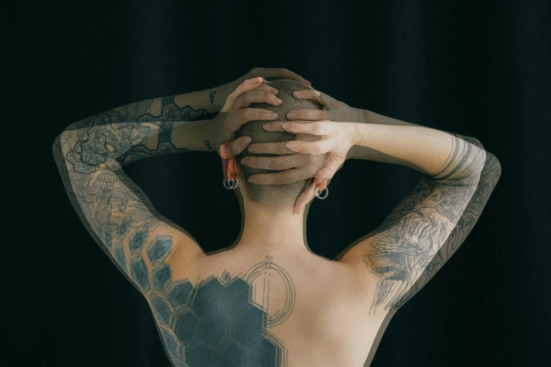 a tattooed woman covering her face with her hands, trending on pexels, hyperrealism, black human spine, geometrically realistic, multiple arms, a photo of a man