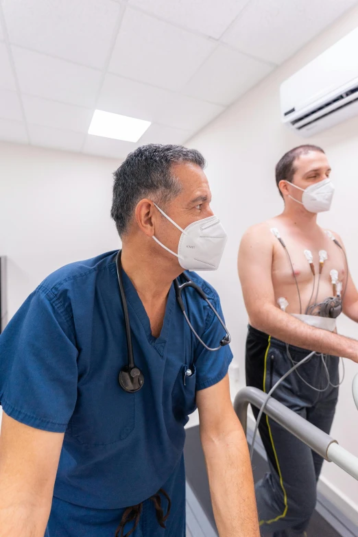 a couple of men standing next to each other in a room, with a stethoscope, simulation, chest, grey