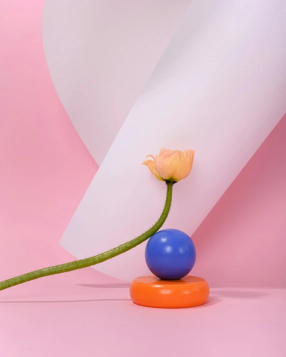 a flower sitting on top of a blue and orange object, holding a balloon, product image, single subject, bubblegum pop