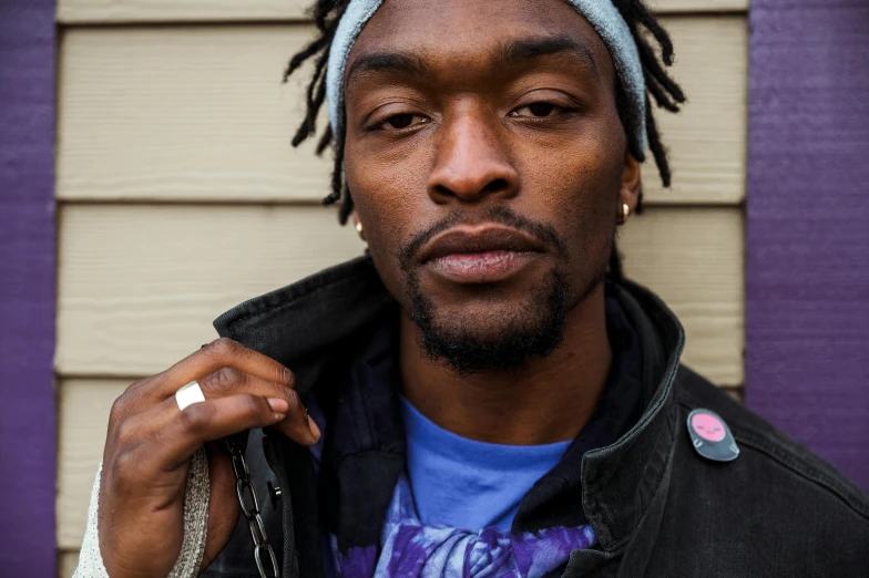 a man with dreadlocks standing in front of a house, by Stokely Webster, close up portrait photo, ap art, wiz khalifa, promotional image