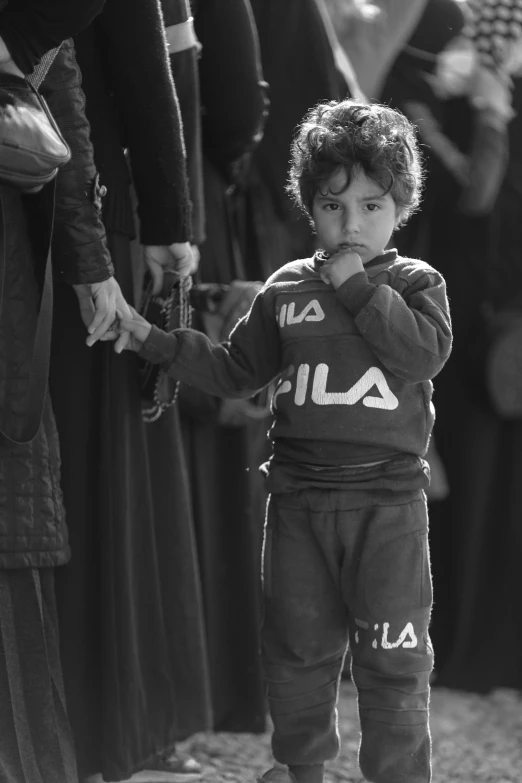 a little boy that is standing in the dirt, by Francesco Filippini, hurufiyya, martial arts tournament, streetwear, mo salah, detail