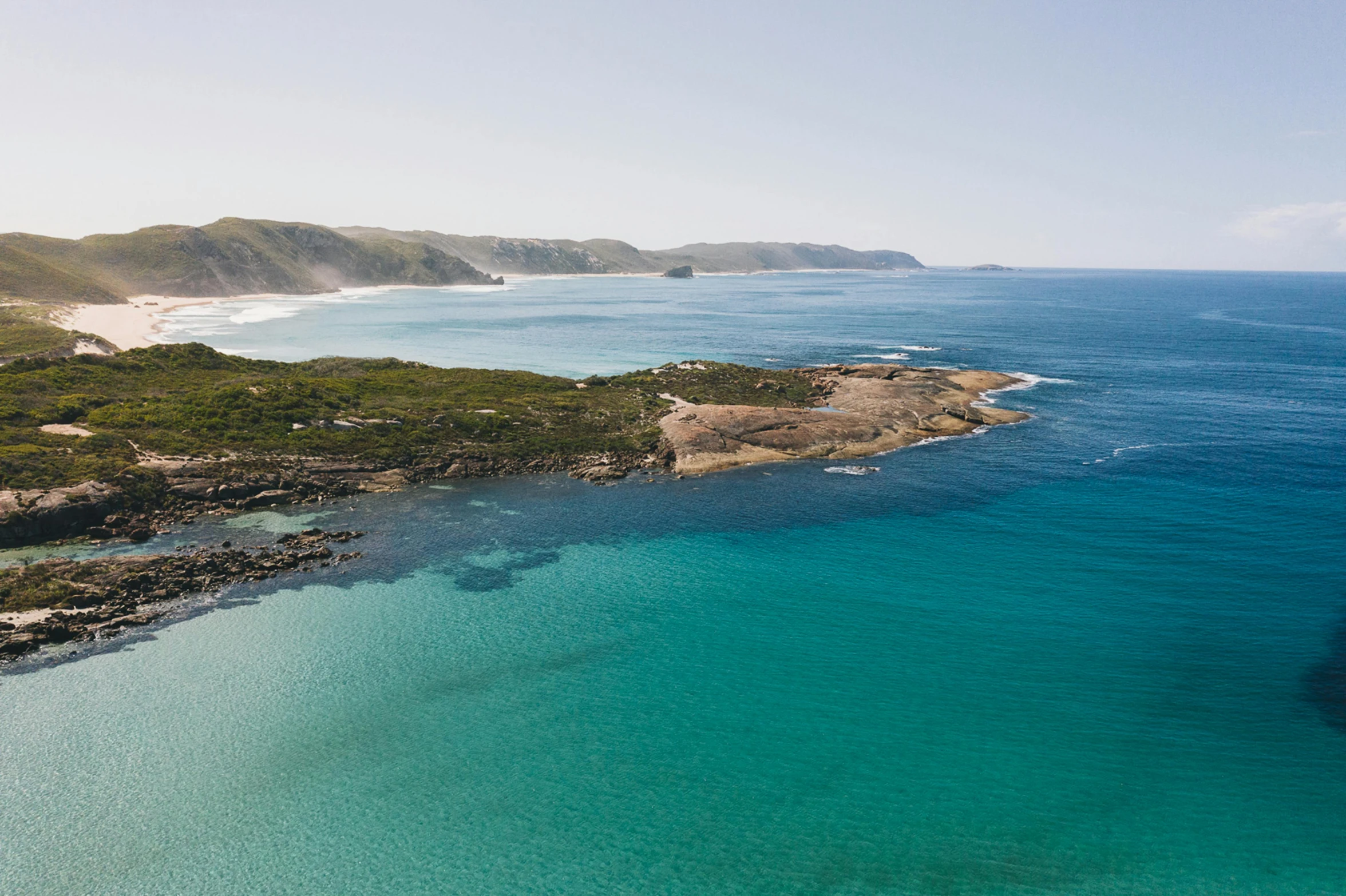 a large body of water next to a beach, pexels contest winner, straya, beach is between the two valleys, cape, ben nicholas