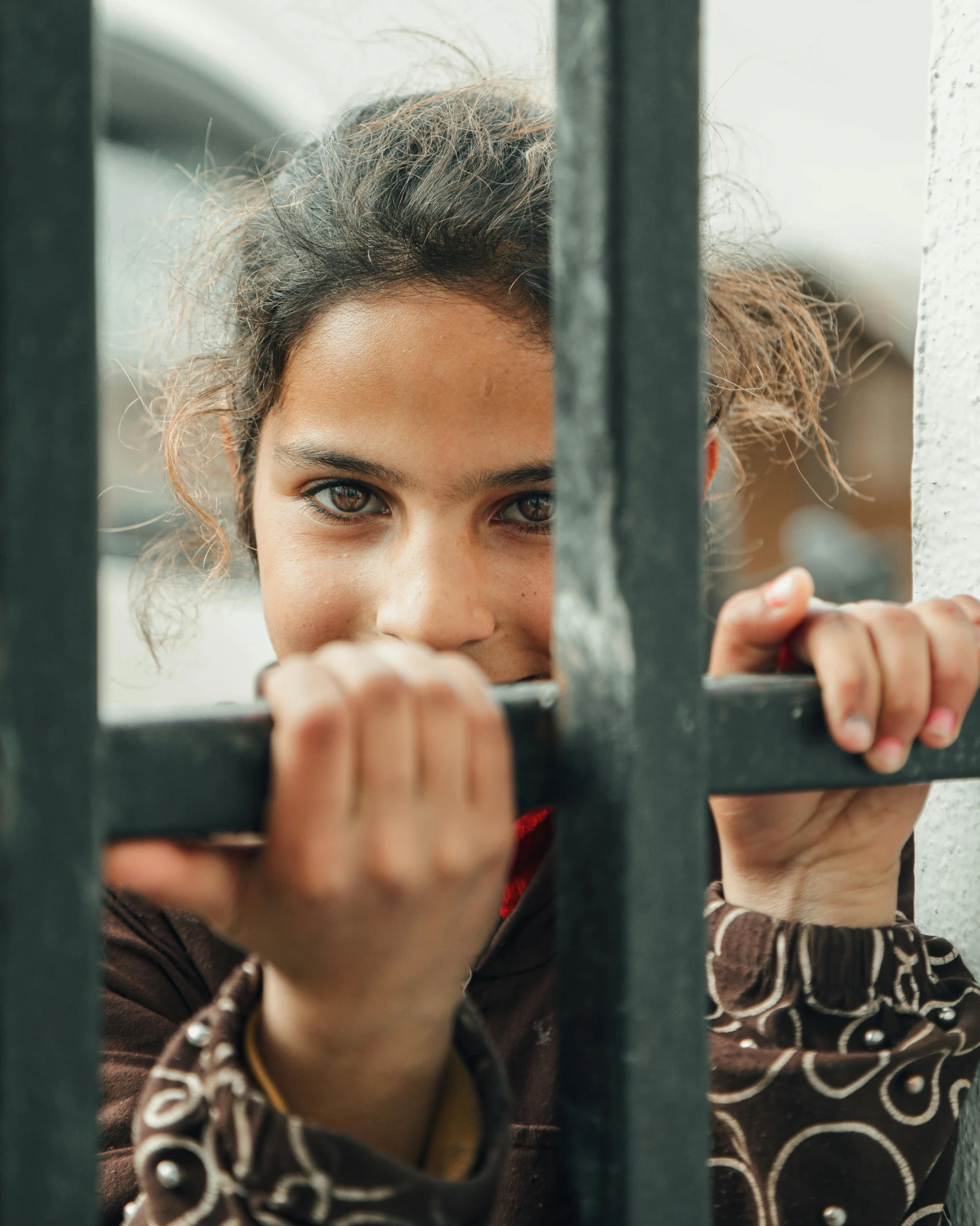 a close up of a person behind a fence, a colorized photo, by Maryam Hashemi, trending on pexels, hurufiyya, stood in a cell, happy girl, arrested, square