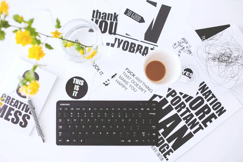 a keyboard sitting on top of a desk next to a cup of coffee, a black and white photo, trending on pexels, computer art, etsy stickers, typographic, background image