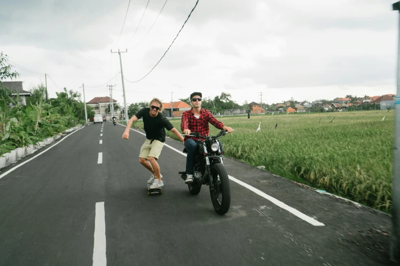 a couple of men riding on the back of a motorcycle, unsplash, happening, bali, joe biden riding a skateboard, avatar image, b - roll