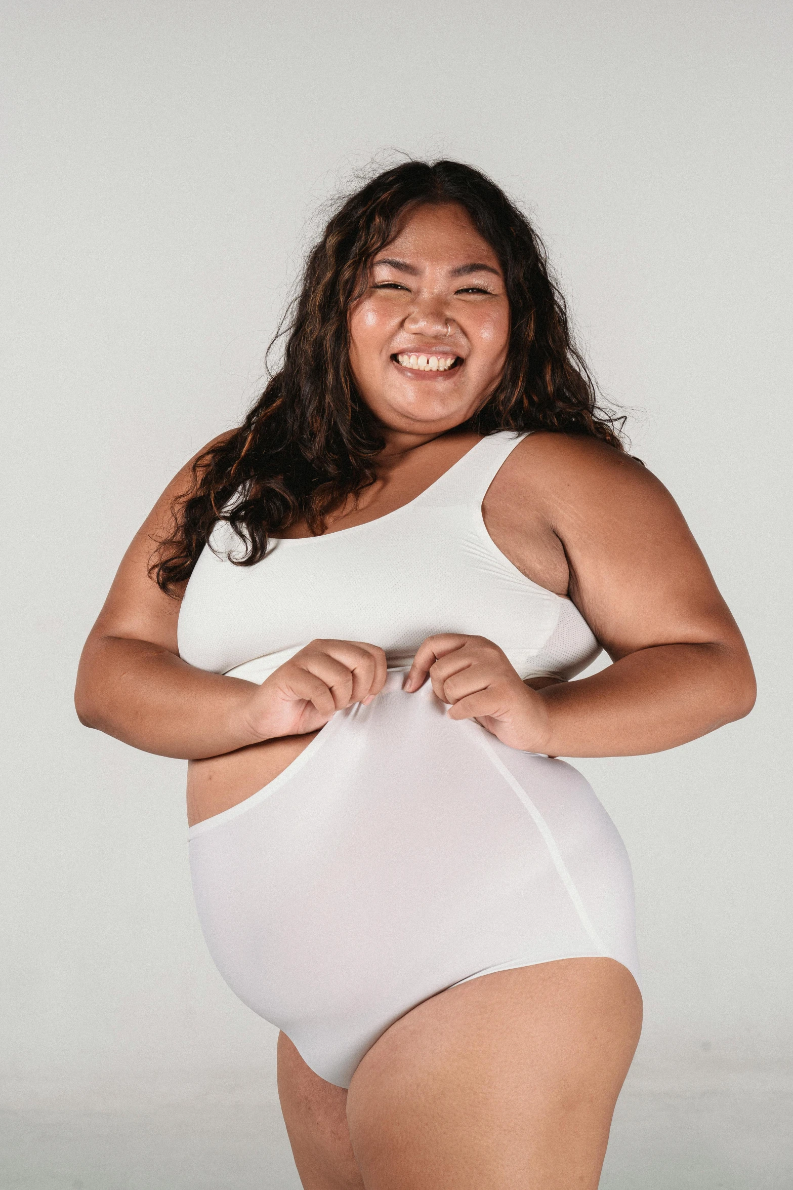 a woman in a white bodysuit posing for a picture, inspired by Ruth Jên, pexels contest winner, happening, diaper-shaped, wearing a tanktop and skirt, bbwchan, indonesia