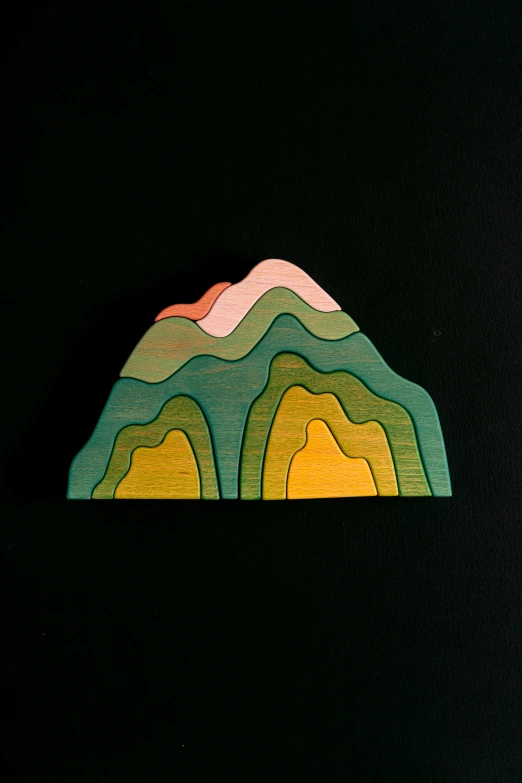 a piece of art sitting on top of a table, by Sam Havadtoy, trending on unsplash, volcano valley, wooden art toys, coloured woodcut, elevation view