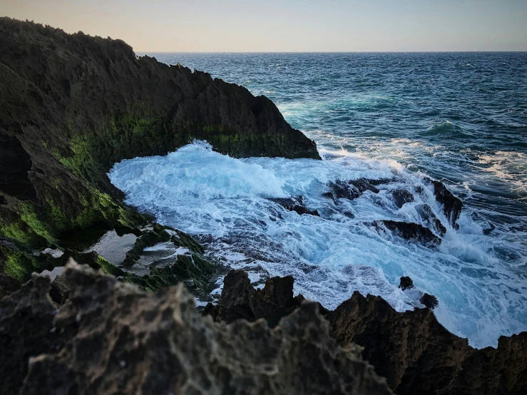 a large body of water next to a rocky shore, unsplash, happening, charybdis, slide show, australian beach, profile image