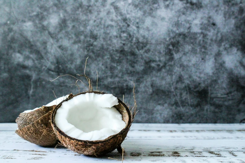 a whole coconut sitting on top of a wooden table, by Elaine Hamilton, unsplash, background image, epicurious, white, panel