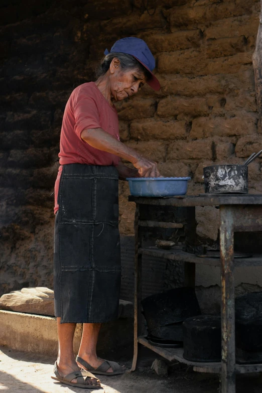 a woman that is standing in front of a stove, brujeria, farmer, profile image