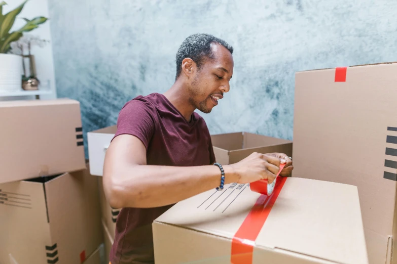 a man opening a box with a red ribbon, pexels contest winner, hurufiyya, avatar image, maintenance photo, used tape, moving