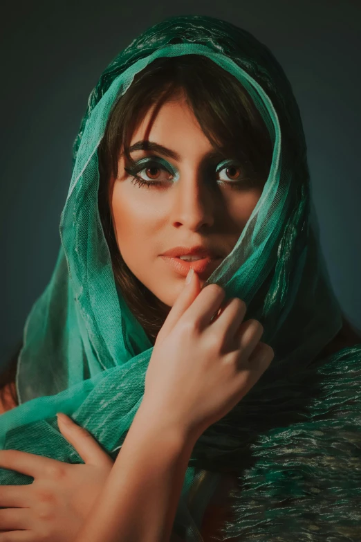 a woman with a green scarf on her head, a colorized photo, trending on pexels, arabesque, ((greenish blue tones)), handsome girl, beautiful iranian woman, 5 0 0 px models