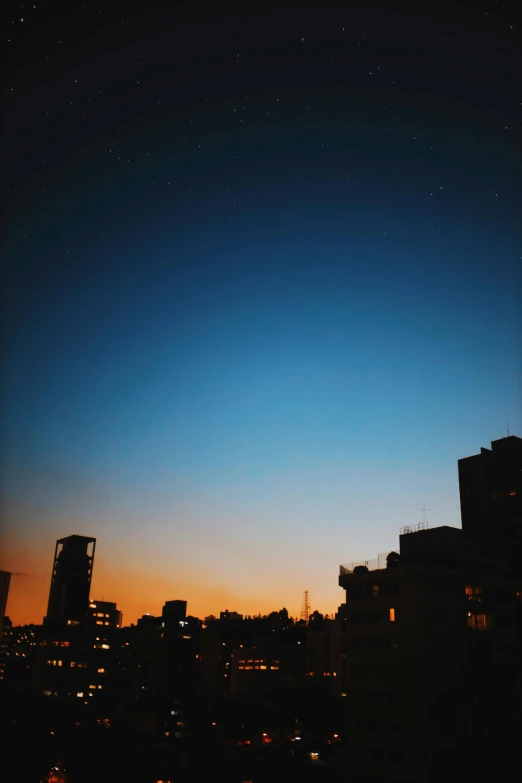 a city skyline at night with the moon in the sky, a picture, unsplash contest winner, minimalism, buenos aires, ((sunset)), blue clear sky, film photo
