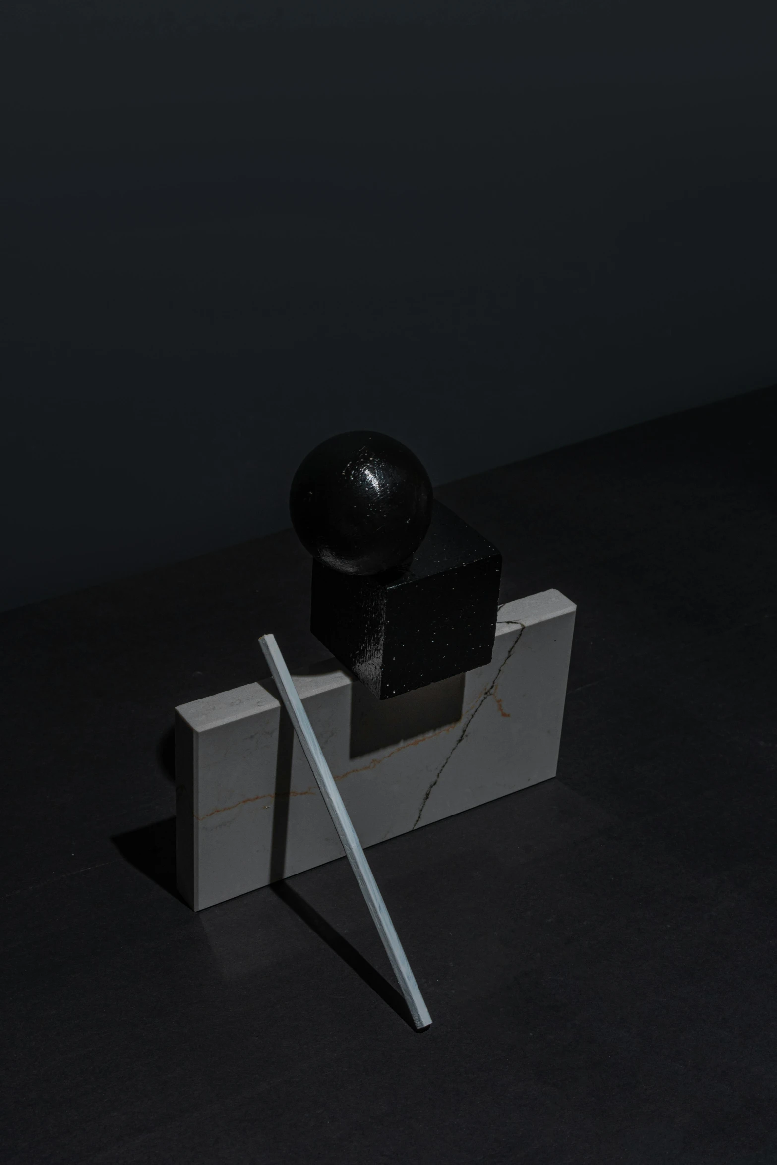 a black hat sitting on top of a white object, an abstract sculpture, by Harvey Quaytman, unsplash, suprematism, launching a straight ball, carved black marble, ignant, stanchions