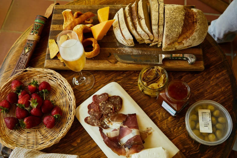 a table topped with lots of food on top of a wooden table, cheese and salami on the table, slide show, medium-shot, well list