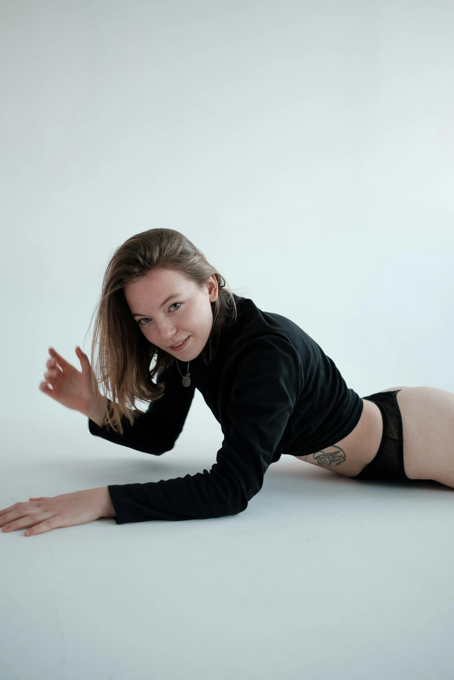 a woman laying on the floor posing for a picture, profile image, mia kischner, on a white table, bending down slightly