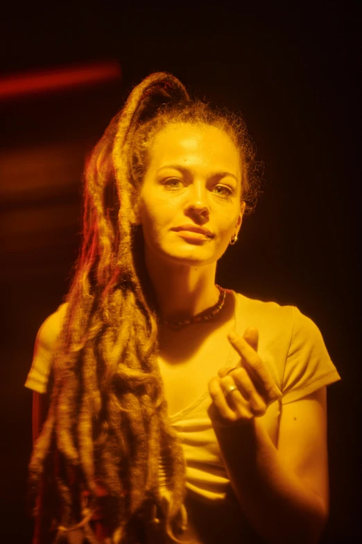 a woman with dreadlocks posing for a picture, a portrait, inspired by Nan Goldin, pexels contest winner, light show, film still from 'tomb raider', anjali mudra, looking to the right