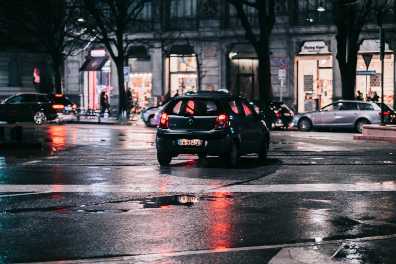 a car that is sitting in the street, by Thomas Häfner, pexels contest winner, city led lights, wet asphalt, 🚿🗝📝