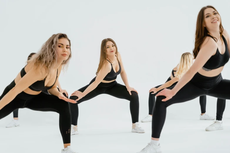 a group of women doing yoga poses on a white background, an album cover, by Emma Andijewska, trending on pexels, arabesque, thick smooth warframe thighs, squatting, black spandex, 8 k -